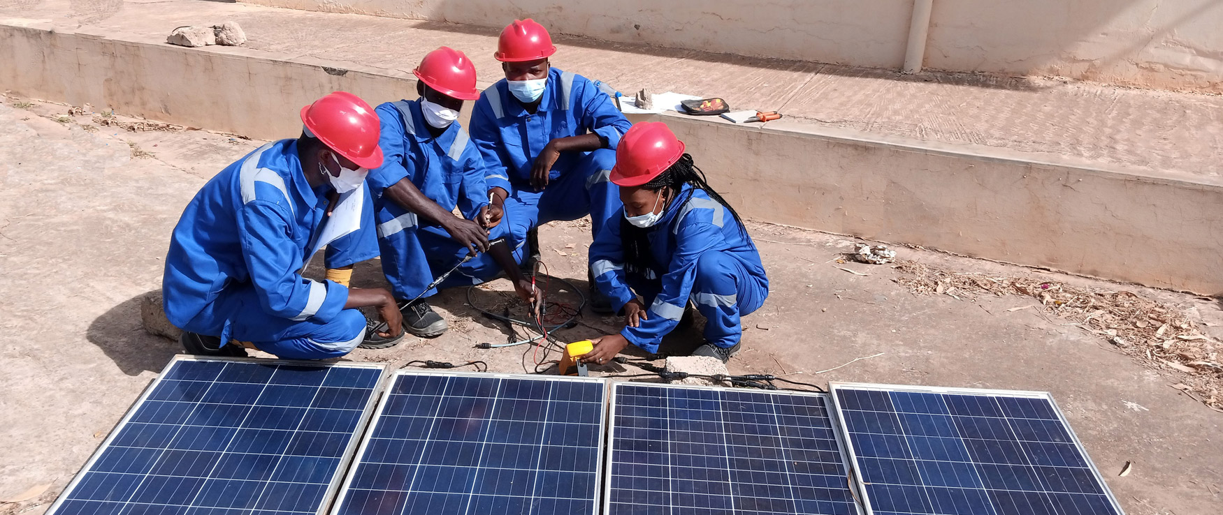 Mitarbeiter vor der Solarenergieanlage im Senegal