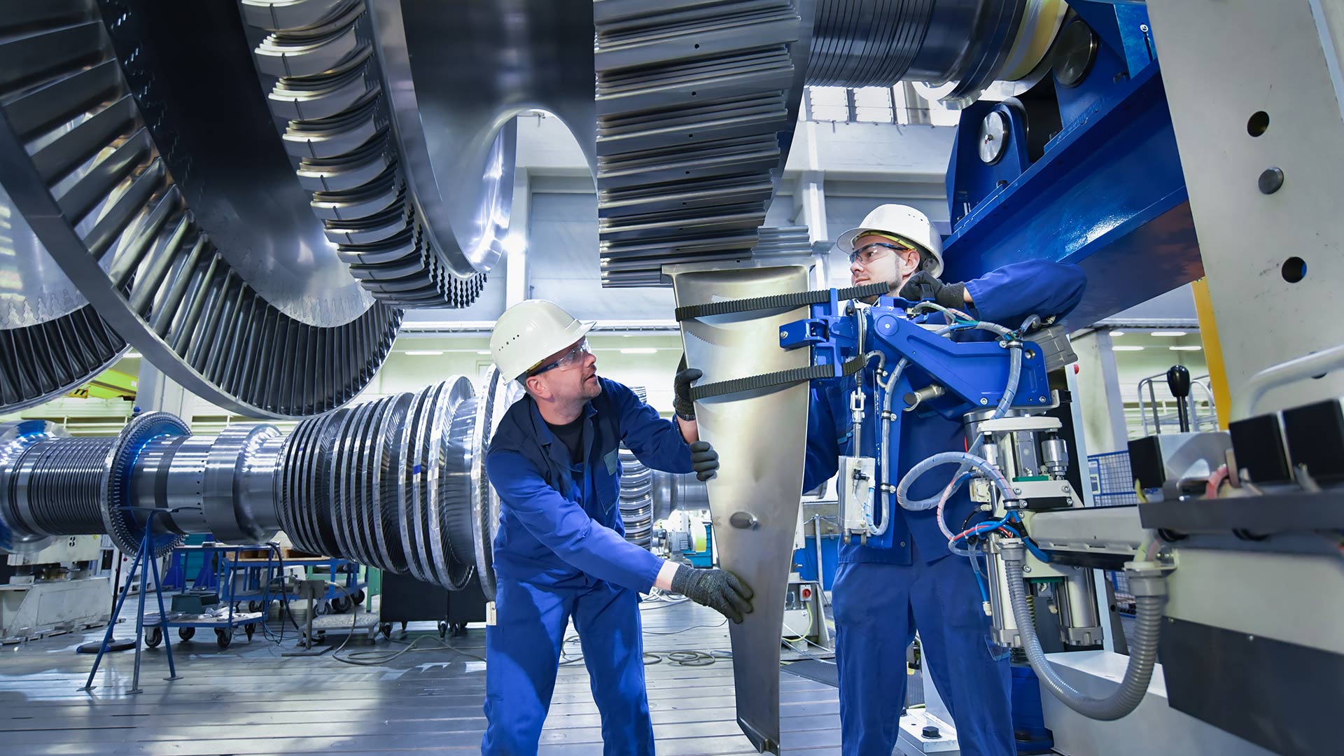 Employees of a production plant insert machine parts