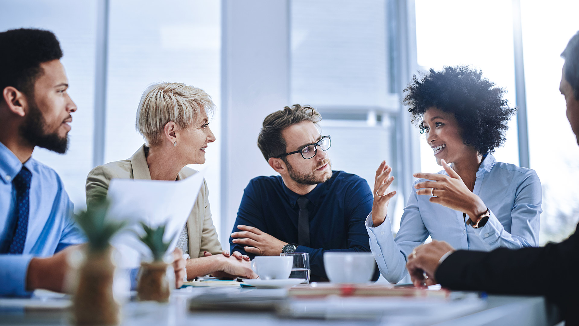 Employees exchange ideas during a meeting